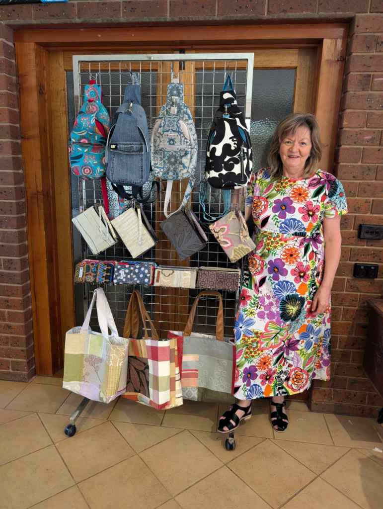 Photo of Maree Slatter with examples of her work